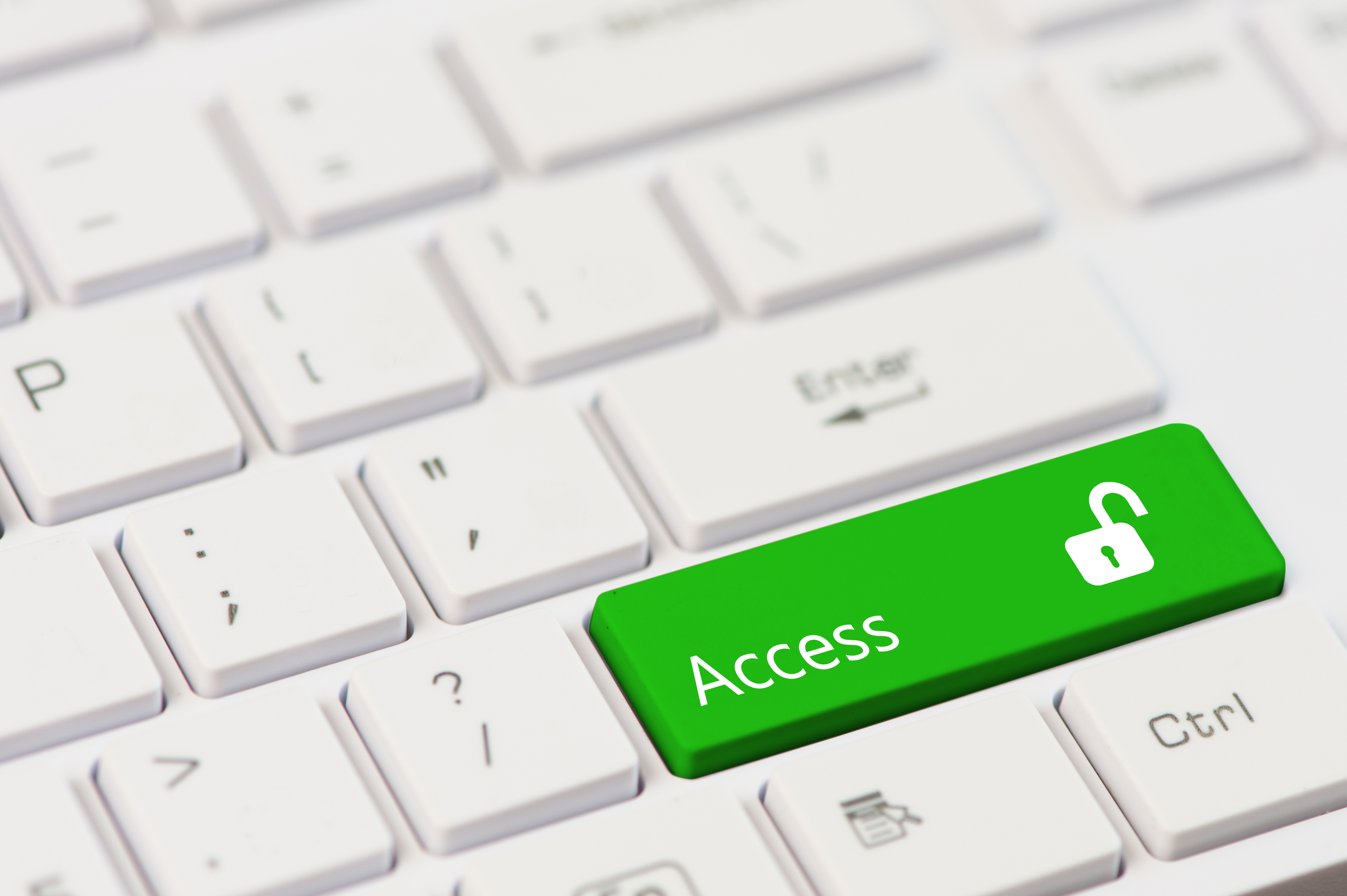 A white computer keyboard with a large green key labeled Access featuring an open padlock icon, positioned where the Enter key typically is.